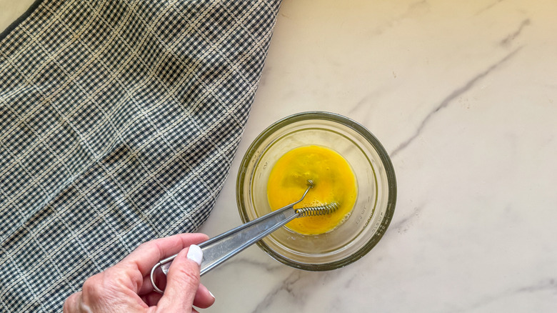 hand stirring egg wash