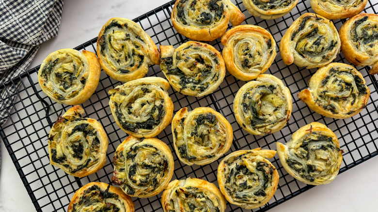 Spinach artichoke pinwheels on cooling rack