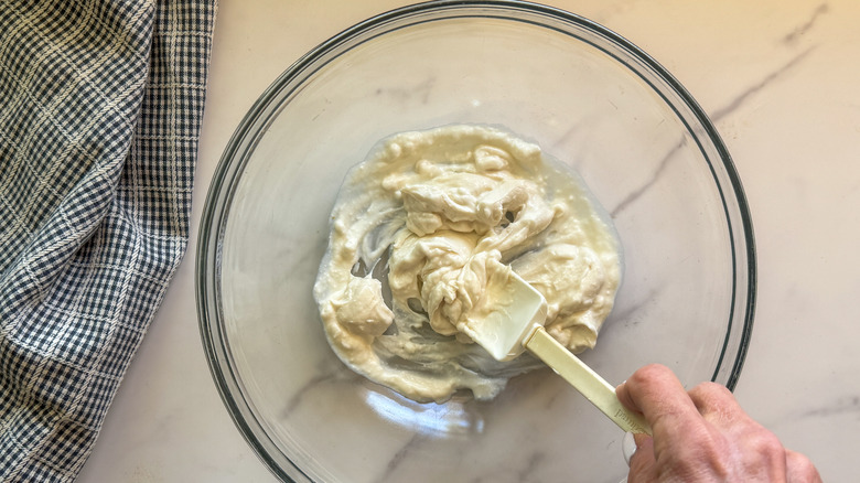 Stirring mayonnaise mixture in bowl