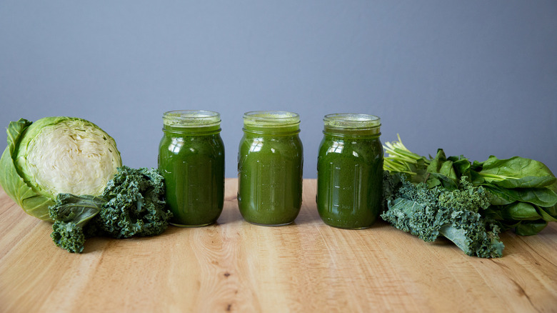three green juices on table