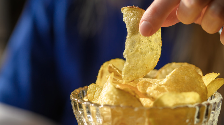 Close-up of a foodie eating a bowl of chips