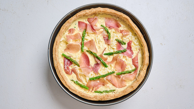 egg, cheese, and prosciutto in a quiche crust