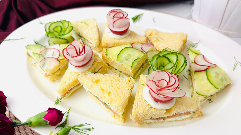 Tea sandwiches garnished with radish and cucumber flowers