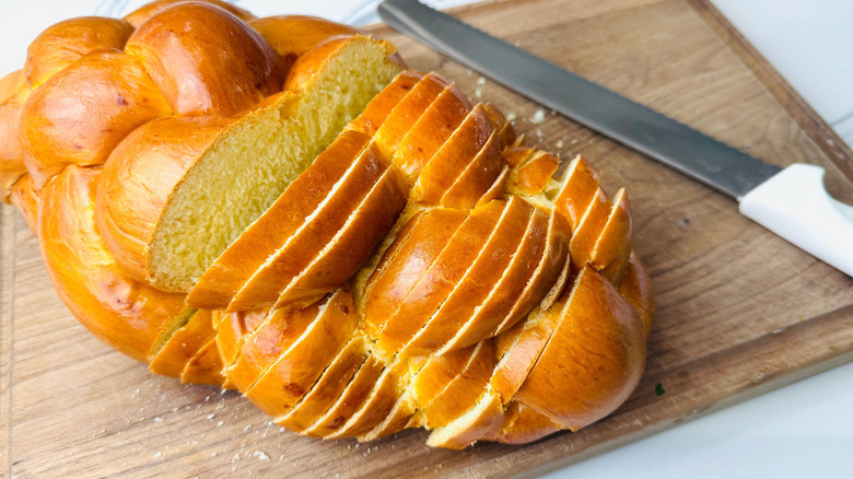 Sliced challah on wooden board