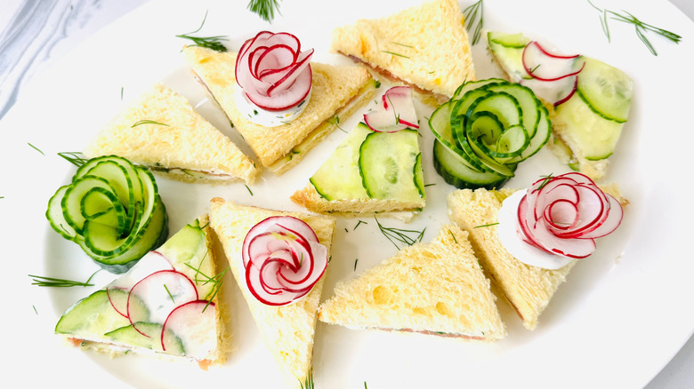 Tea sandwiches garnished with radish and cucumber flowers