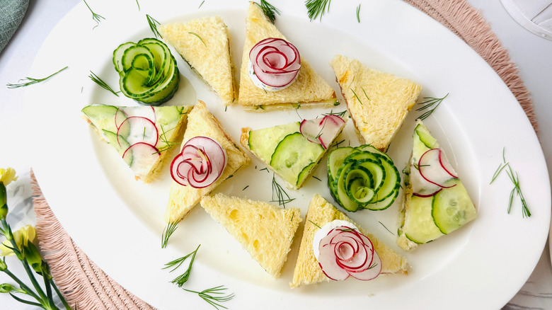 Tea sandwiches garnished with radish and cucumber flowers
