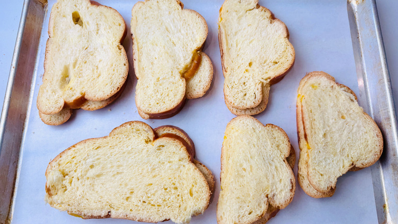 Slices of bread on baking sheet