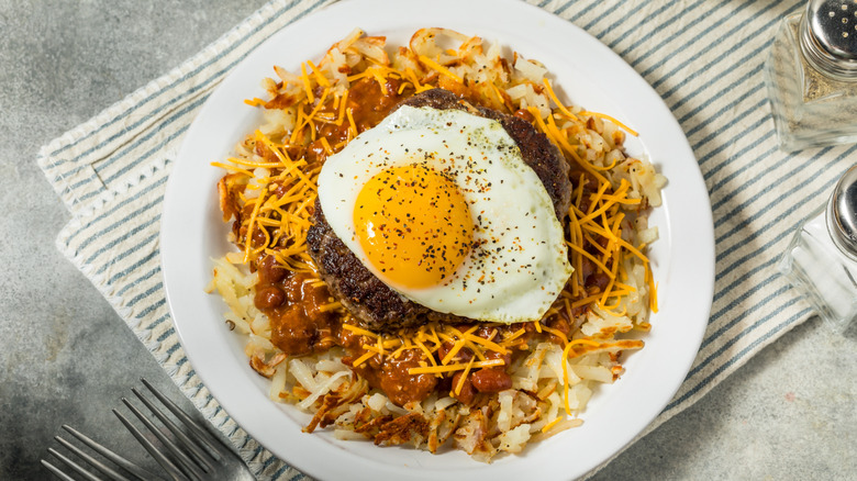 Aerial view of a St. Louis Slinger on a white plate set atop a striped tea towel