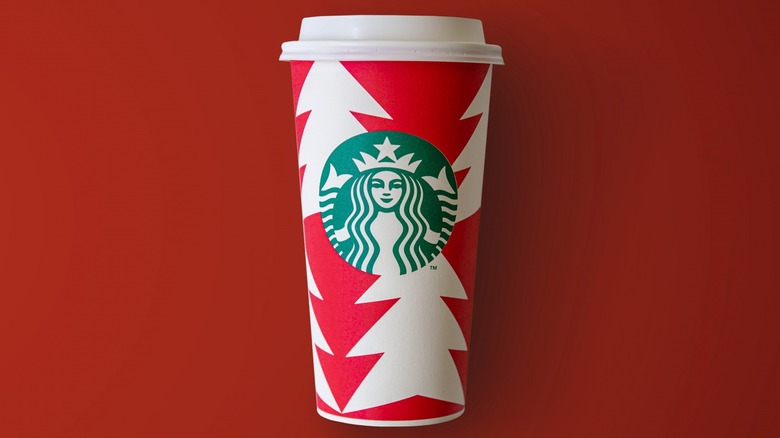 Starbucks paper holiday cup on a red background