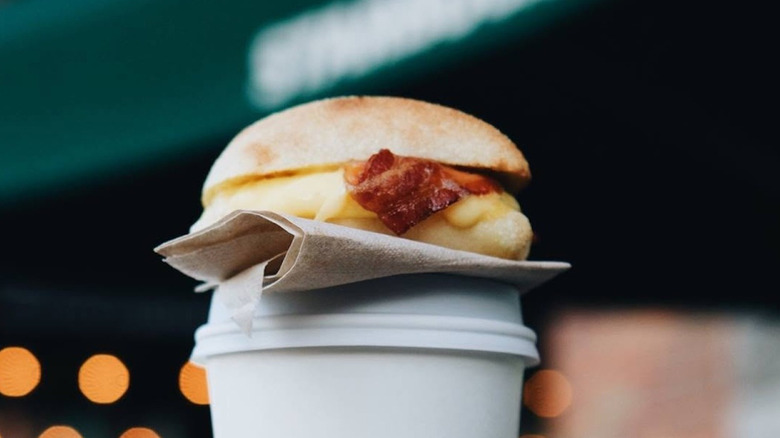 Starbucks' Bacon, Gouda & Egg sandwich on coffee cup