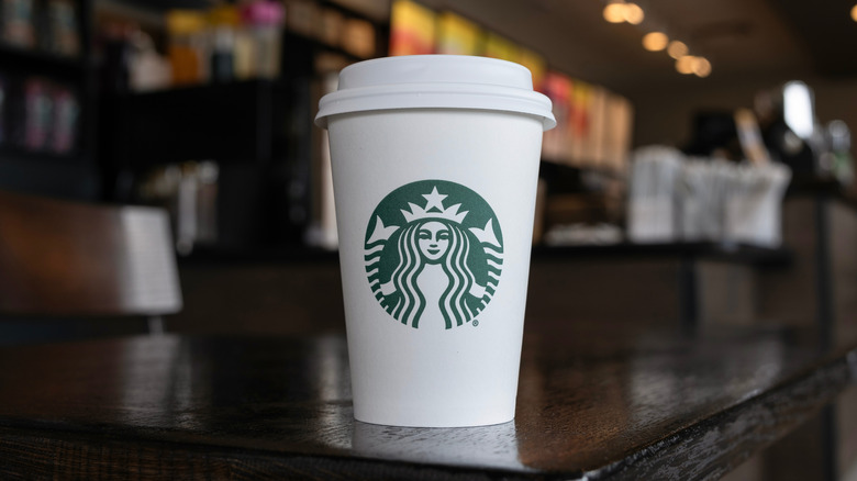 A Starbucks cup on a table.