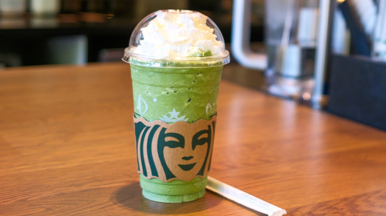 Starbucks Matcha Crème Frappuccino sitting on wooden counter