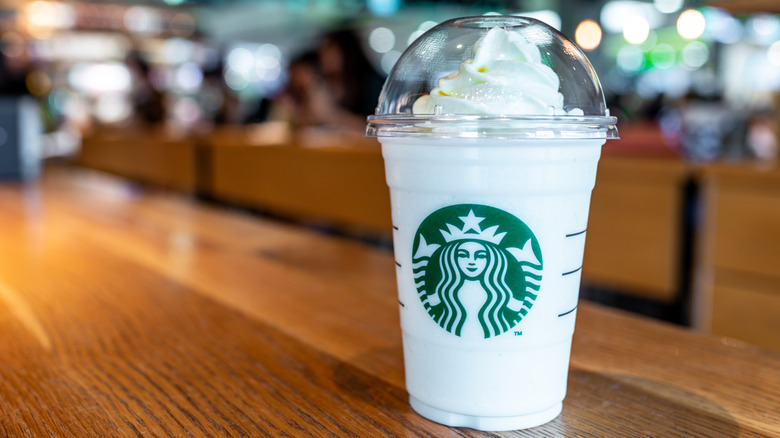 Starbucks Vanilla Bean Cr&egrave;me Frappuccino on wooden countertop