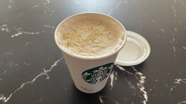 Overhead shot of Starbucks Pecan Crunch Latte on a black and white background