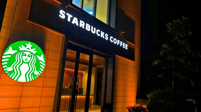 The outside of a Starbucks store at night