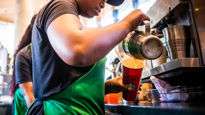 Starbucks barista making drinks