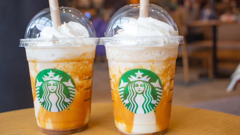 Two creme frappucinos with salted caramel on a table at Starbucks