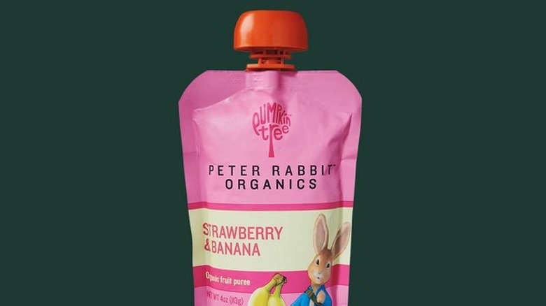 A Peter Rabbit™ Organics Strawberry Banana fruit pouch against a green Starbucks background