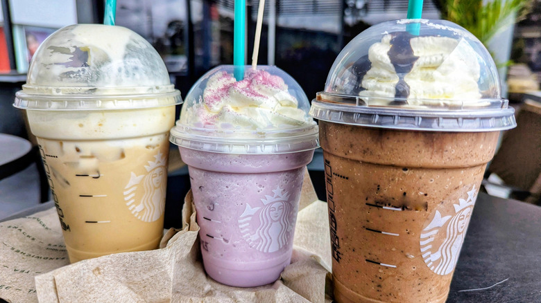 Three Starbucks Frappuccinos in different sizes and colors