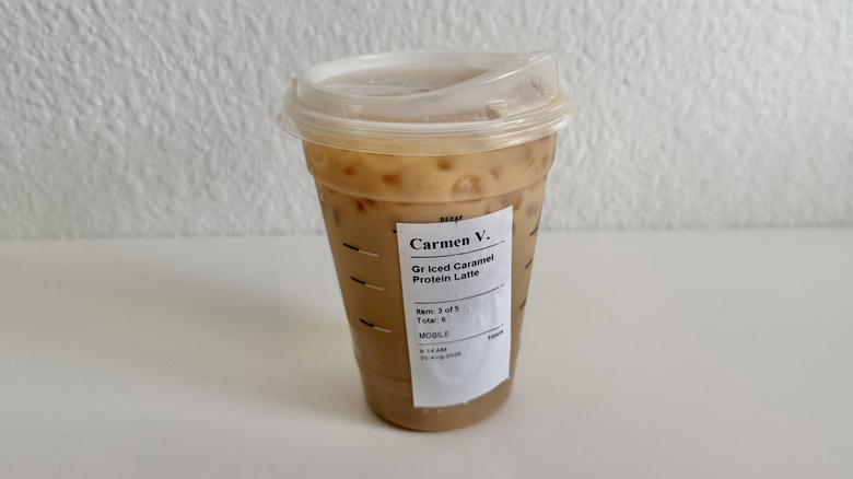 Caramel protein iced latte cup on a table