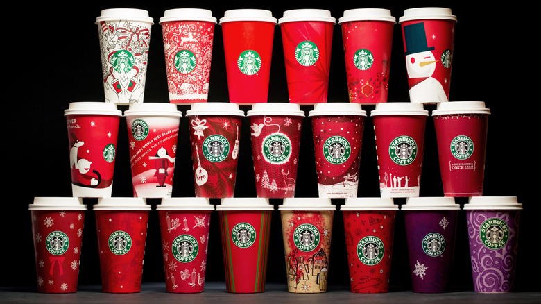 A stacked collection of the Starbucks holiday cups