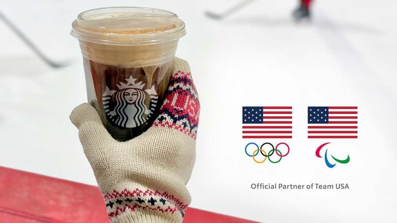 Hand in mitten holding new Starbucks Iced Brown Sugar Honey Americano drink