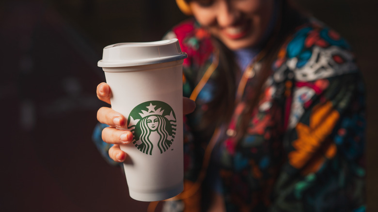 Person holding Starbucks cup