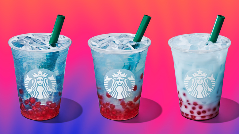 Three blue and red Starbucks Summer-Berry Refreshers with a bright background