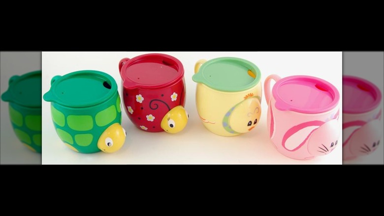 Four kids cups from starbucks against white background