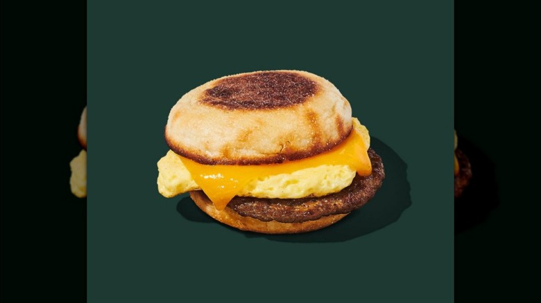 Mirrored image of starbucks breakfast sandwich against green background