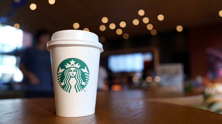 Starbucks cup in darkened store