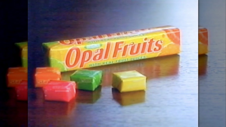 Package and colorful wrapped pieces of Opal Fruits chewy fruit candy seen in TV commercial from 1998