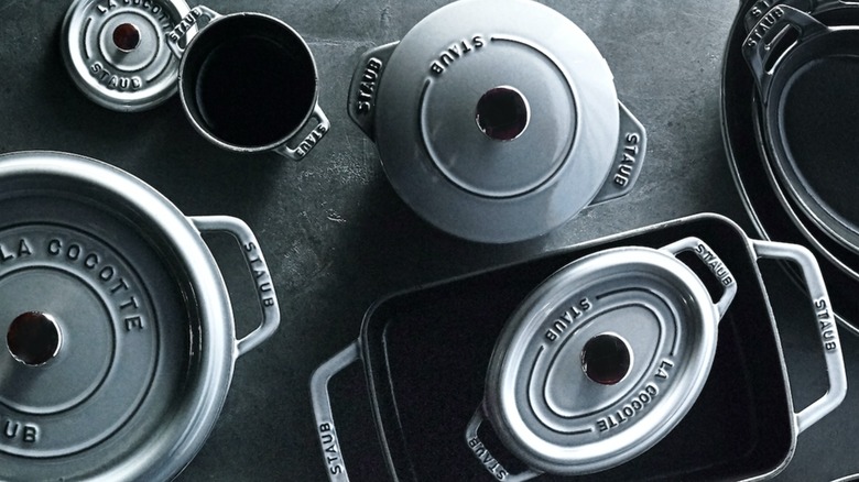 Collection of Staub cookware in gray on gray background