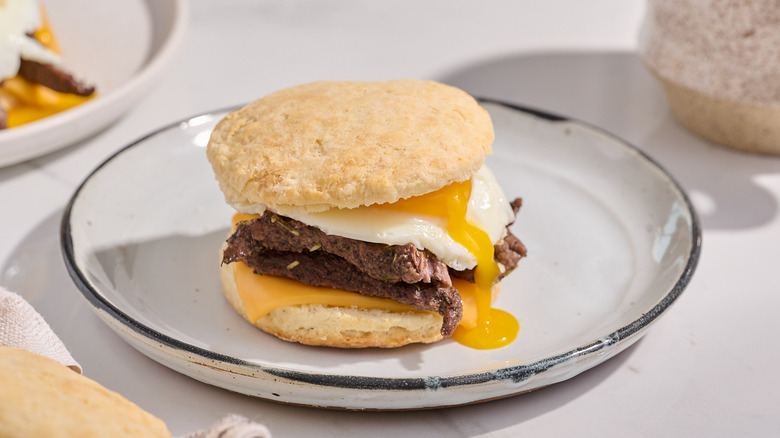 steak and cheese biscuit sandwich on a plate