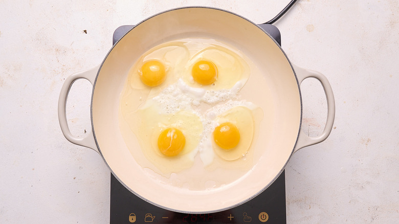 cooking eggs in a large skillet