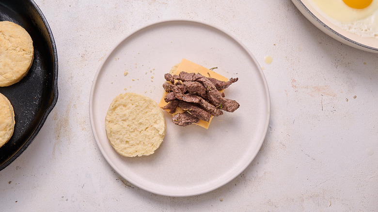 biscuit sliced in half with cheese on top