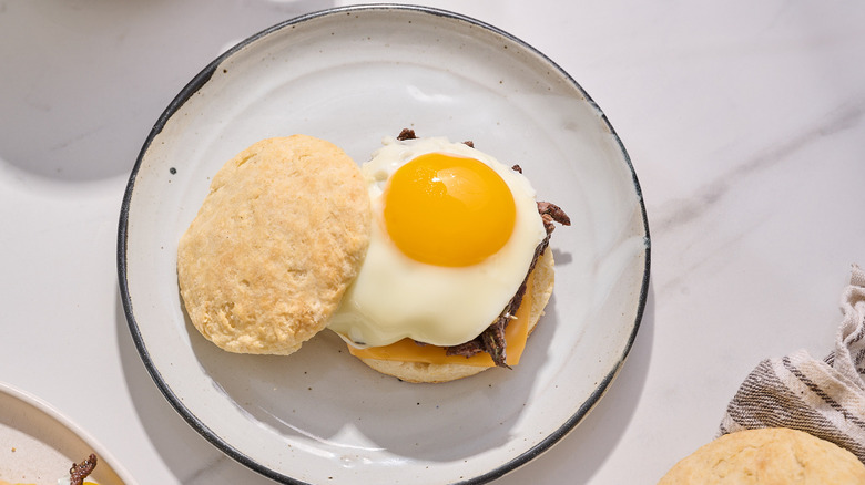 egg on steak and biscuit sandwich