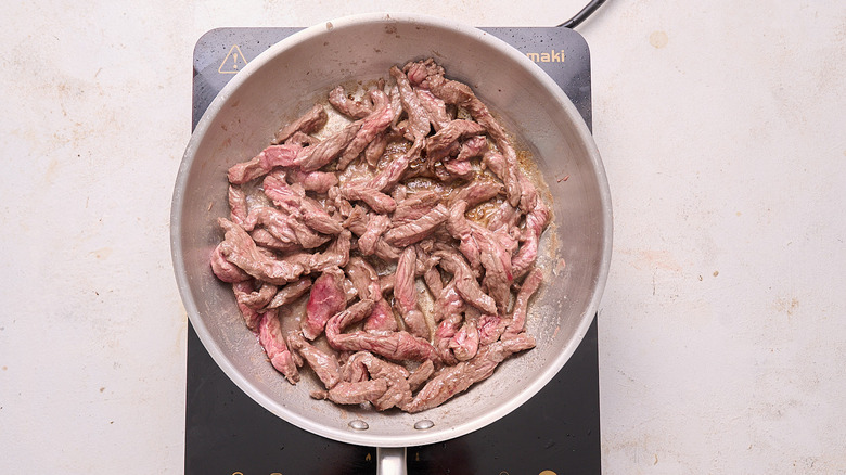 searing steak in a skillet