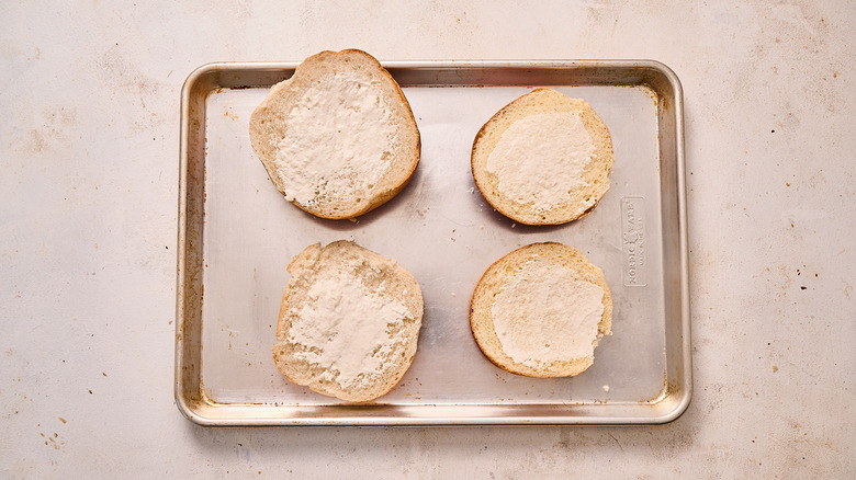 spreading buns with mayonnaise