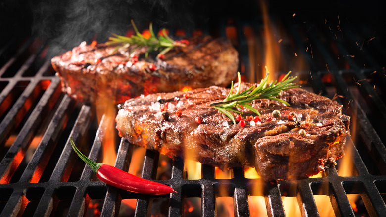 Two porterhouse steaks on grill