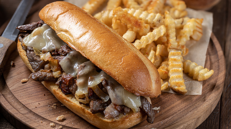 Philly cheesesteak sandwich with crinkle-cut fries