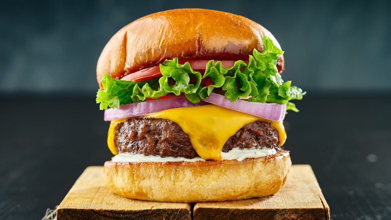 Classic cheeseburger with lettuce, tomato and onion