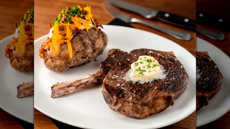 Stoney River Steakhouse and Grill's bone-in cowboy-cut ribeye with a loaded baked potato and butter