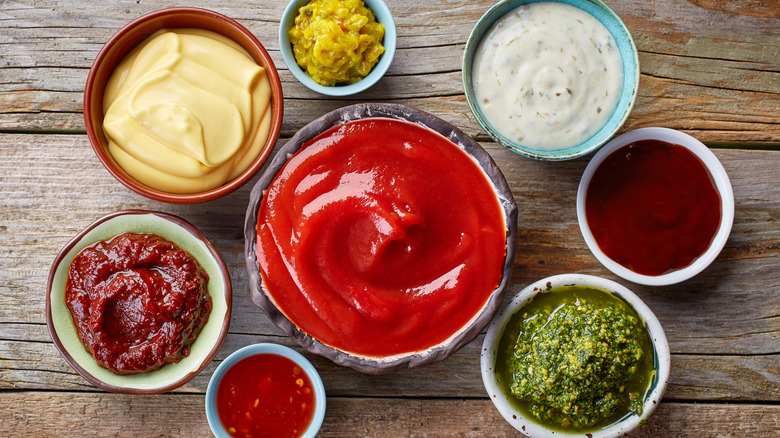 Small bowls of various condiments and sauces