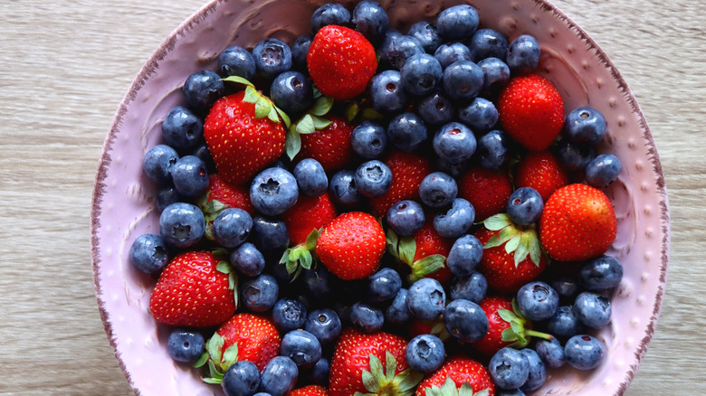 A large bowl of strawberries and blueberries