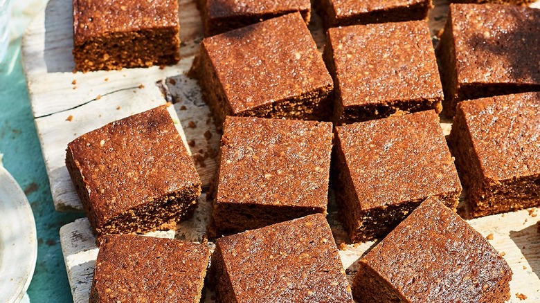squares of parkin, a gingerbread cake, on a wooden serving board