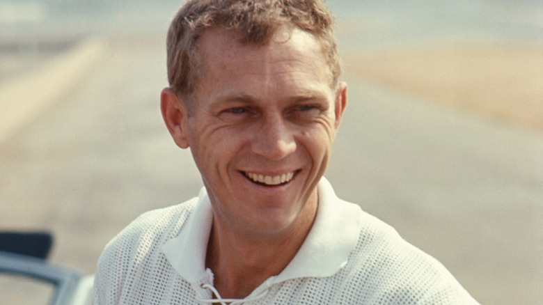 Steve McQueen smiling in white shirt