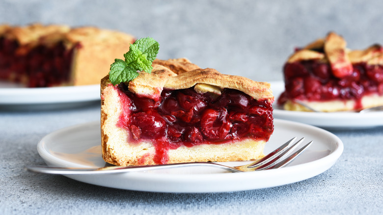 slice of cherry pie on plate with fork