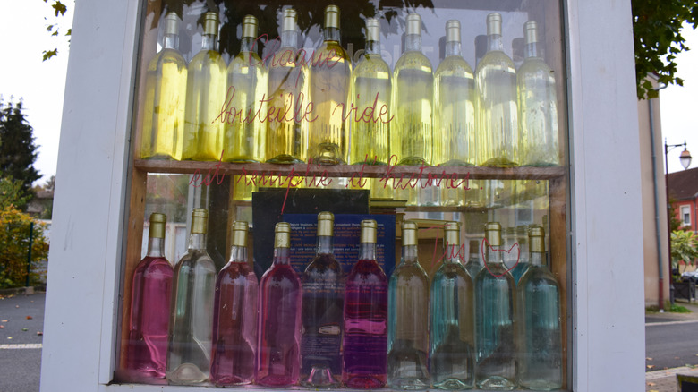 Re-used wine bottles filled with different colors of liquid