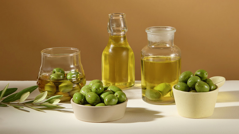 selection of olive oil bottles with olives